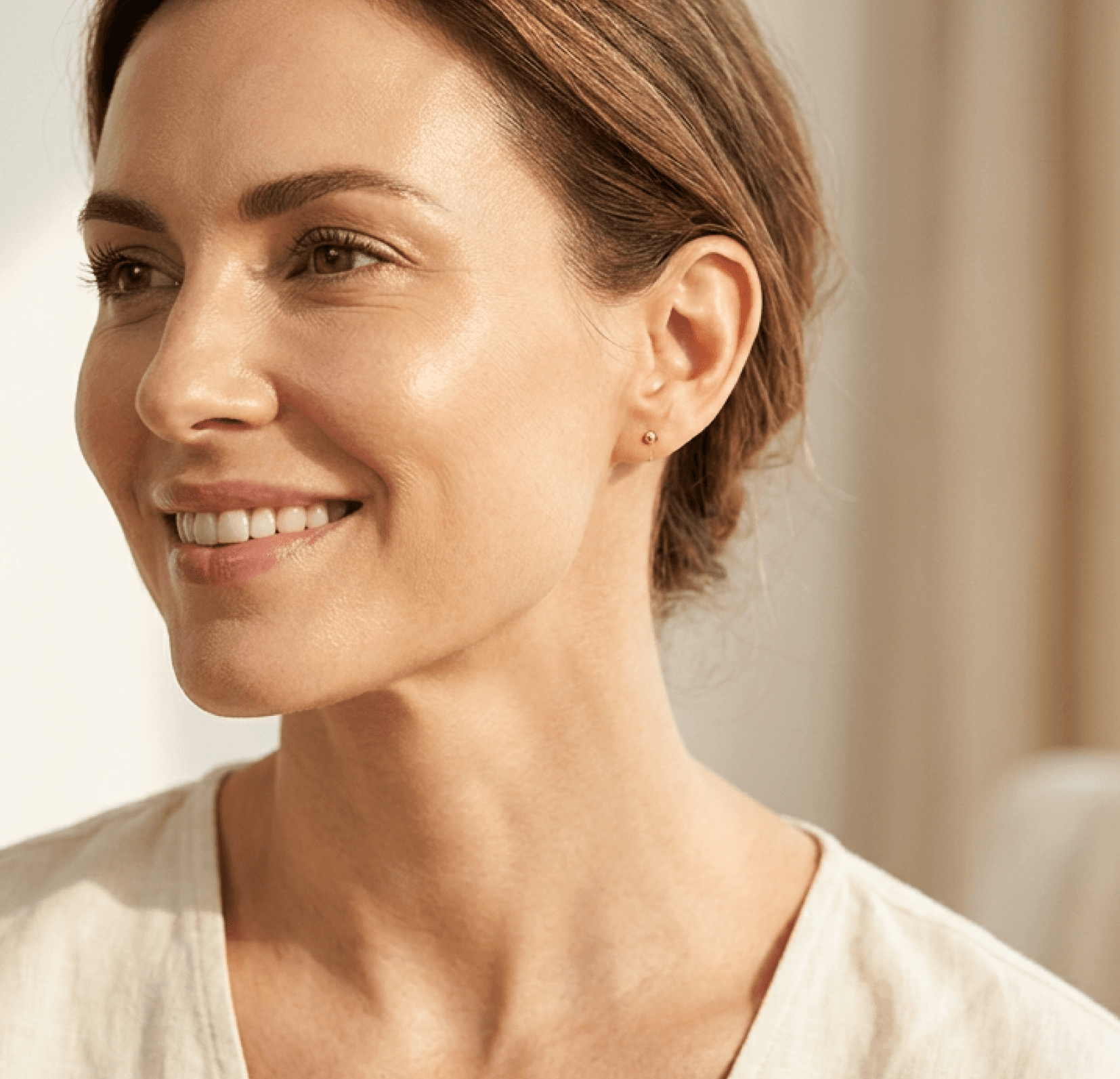 A smiling woman with naturally contoured features