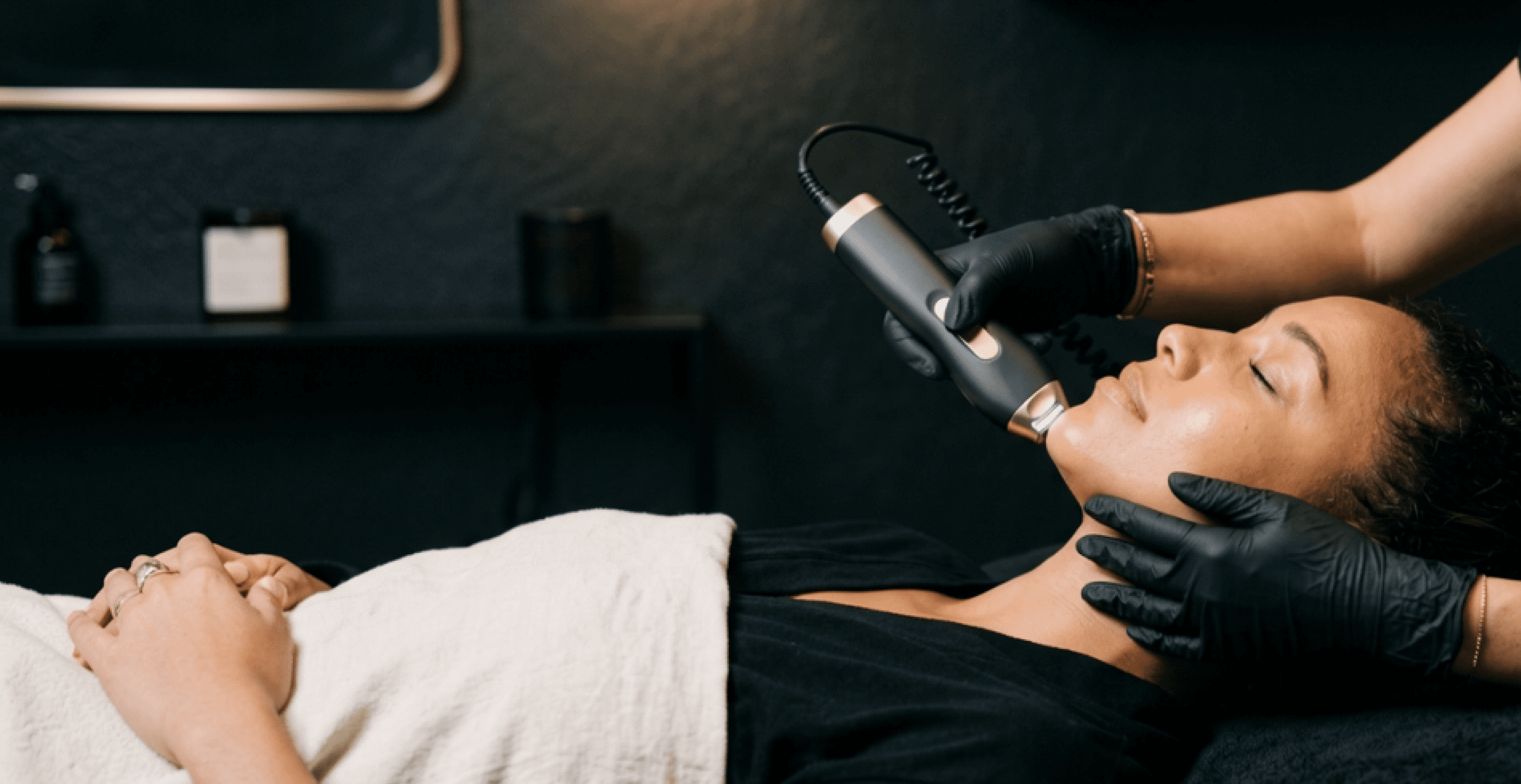 A patient receiving a facial contouring treatment with a handheld device